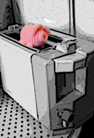 Ein haekelschwein auf einem Toaster.